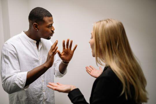 a woman and a man debating in a business setting